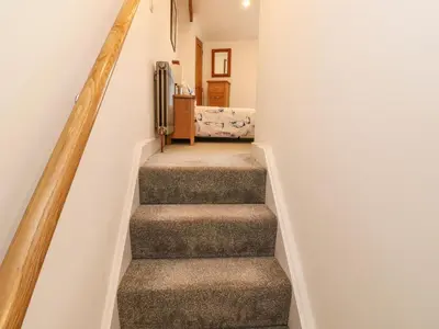 a stairway in a home with white walls at Blue Skies in Hayle