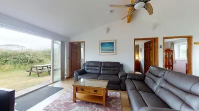 a living room with a couch and a table at F26 Porthia, Riviere Towans in Hayle