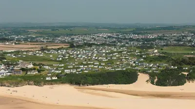 an aerial view of a town on a sandy beach at F26 Porthia, Riviere Towans in Hayle