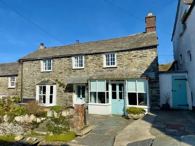 an old stone house with blue doors and windows at Myrtle Cottage Boscastle in Boscastle