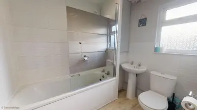 a bathroom with a tub and a toilet and a sink at G05 Horizon G5, Riviere Towans in Hayle