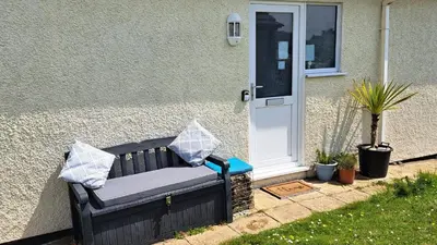 a bench in front of a house with a door at G05 Horizon G5, Riviere Towans in Hayle