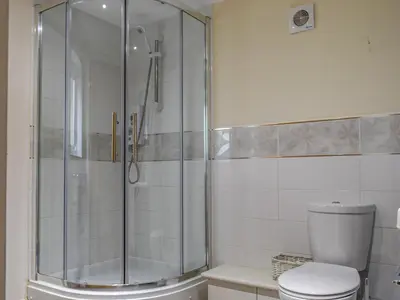 a bathroom with a shower and a toilet at Bolivar Barn in Gwennap