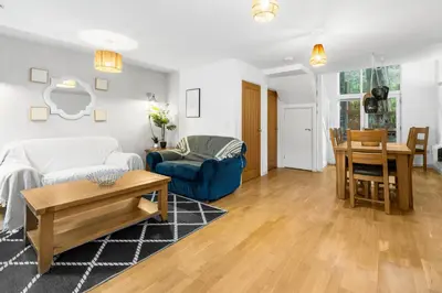a living room with a couch and a table at House 5 Ironcroft - Modern Pet-friendly, Walk to beach & village in Porthtowan