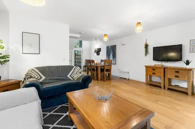 a living room with a couch and a table at House 5 Ironcroft - Modern Pet-friendly, Walk to beach & village in Porthtowan