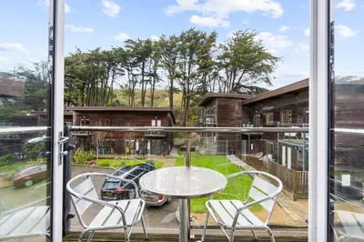 a view of a patio with a table and chairs at House 5 Ironcroft - Modern Pet-friendly, Walk to beach & village in Porthtowan
