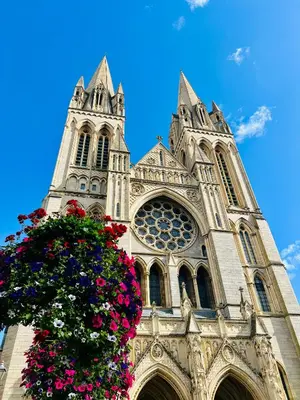 a church with two towers with flowers in front at 8, St Marys , Private Double Ensuite Room - Room Only- Truro in Truro