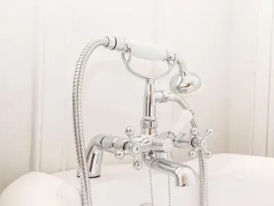 a chrome shower faucet in a bathroom at Trewince Manor Cottage in Truro